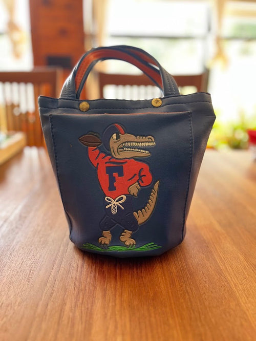 Blue vinyl Gators bucket purse with painted Albert holding a football, front