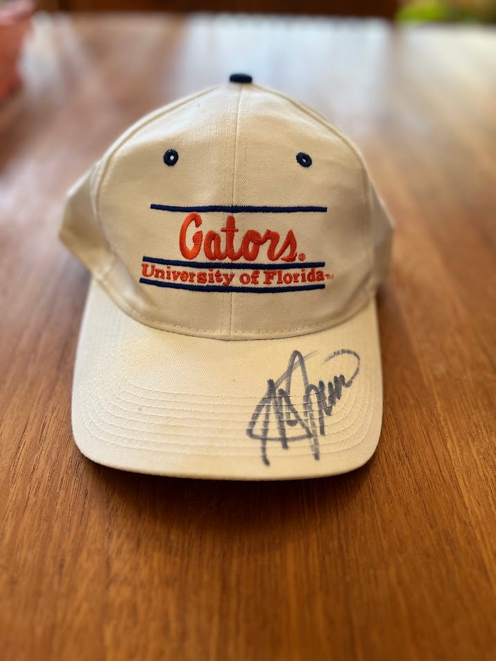 White The Game Gators University of Florida bar cap with blue-ink signature on bill, front