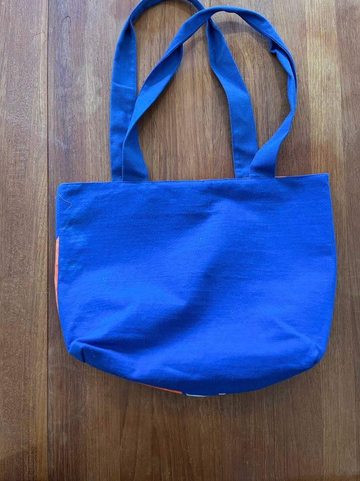 Solid blue back of the hibiscus Gators tote