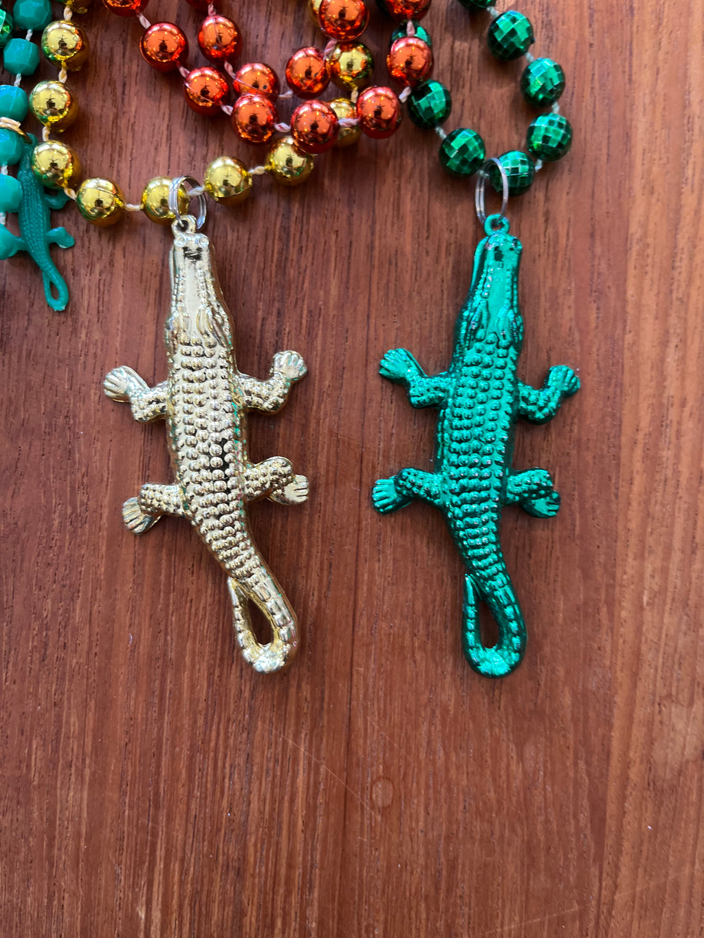 Gold and green alligator pendants close-up