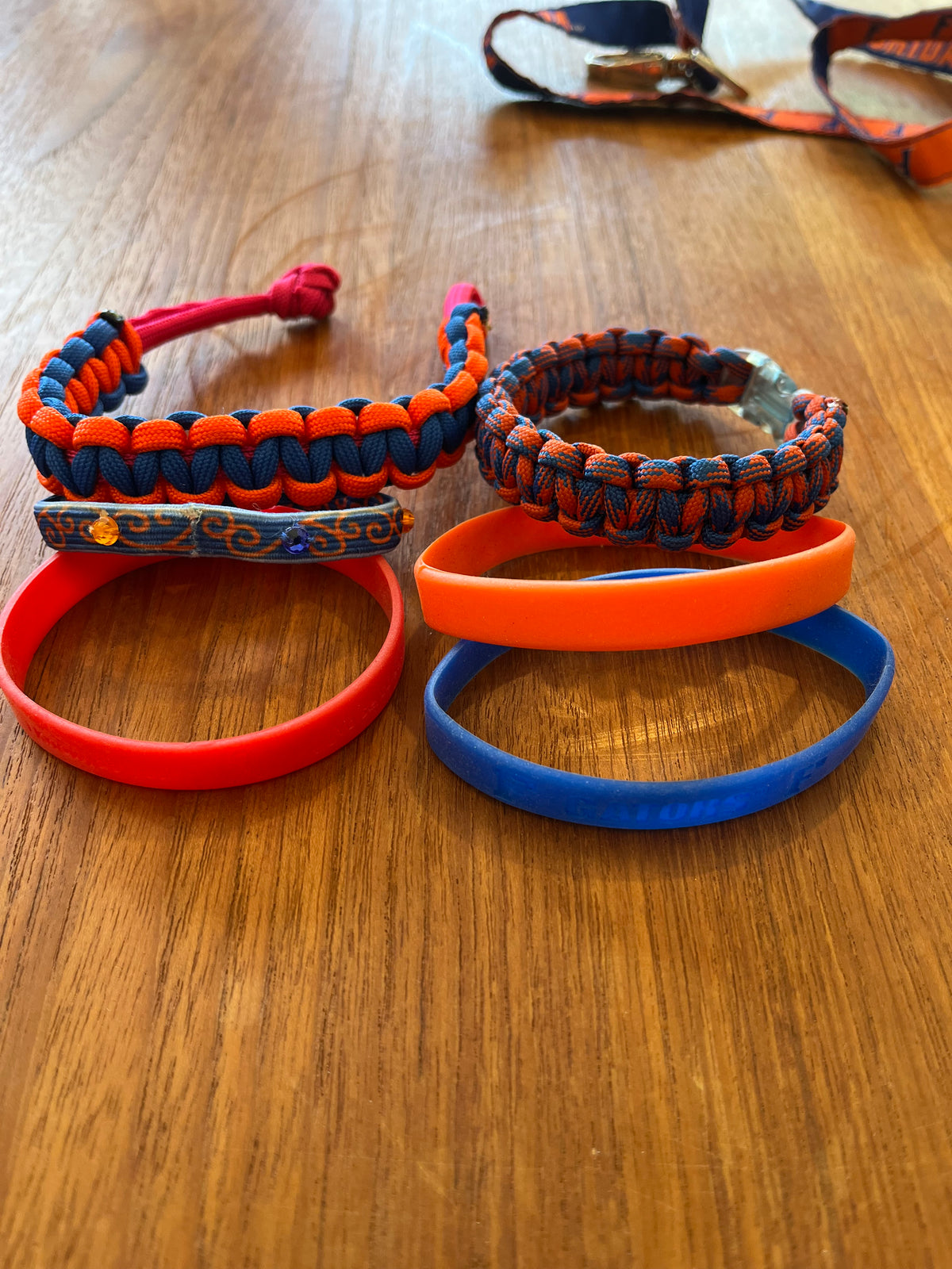 Six Gators bracelets: two paracord, one painted bead bar, three silicone bands