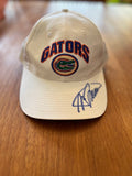 White Top of the World Gators arch cap with blue-ink signature on bill, front