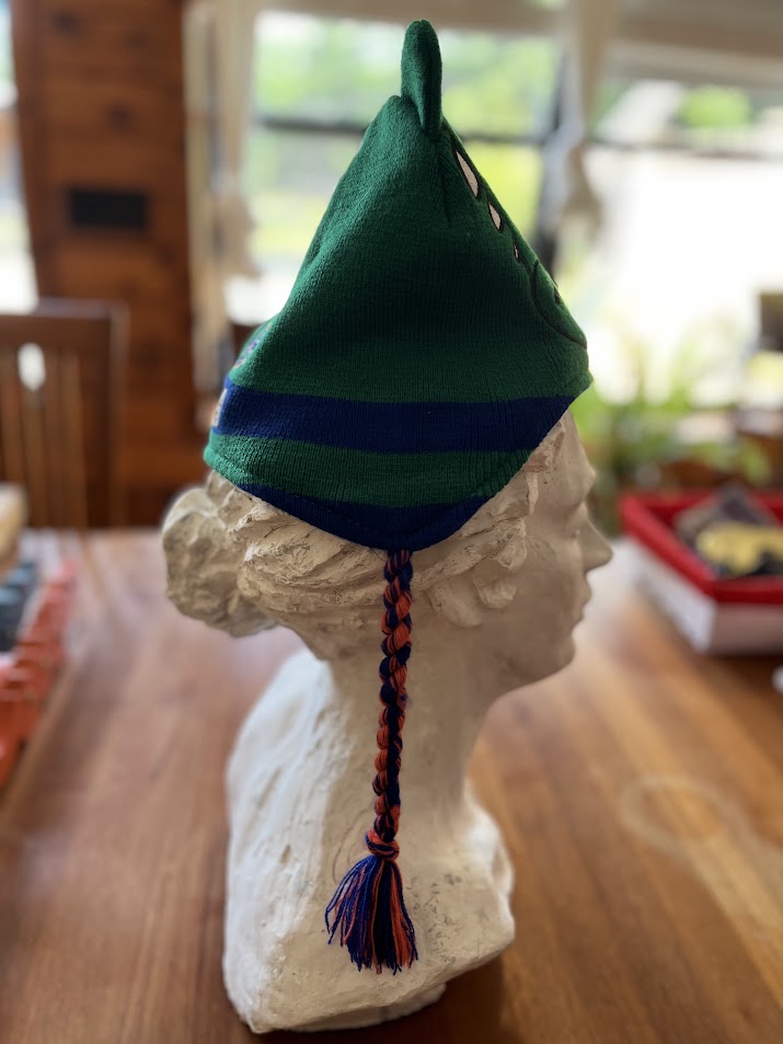 Gators mascot knit hat on display bust, side view with tassel