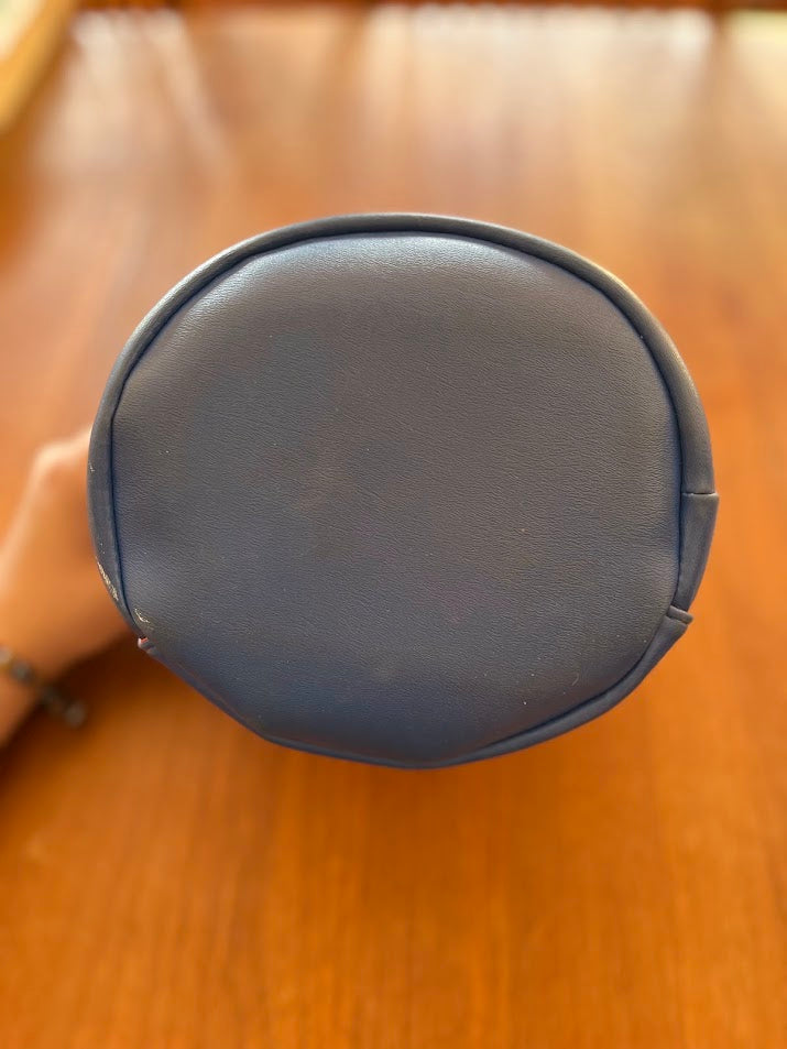 Bottom of blue vinyl Gators purse showing scuffing