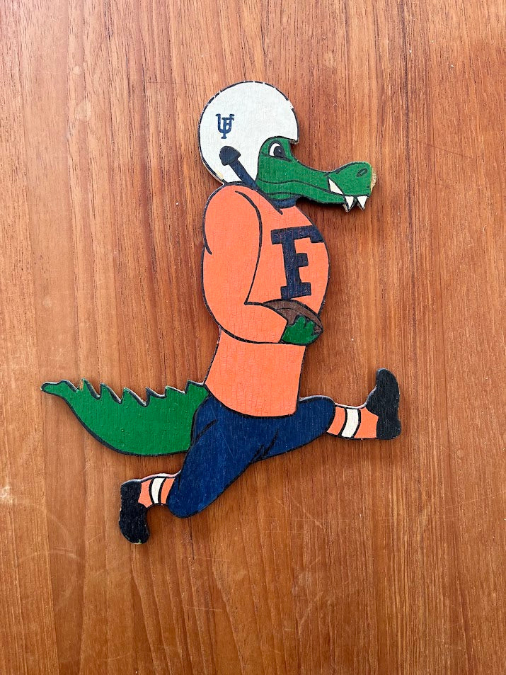 Wood Albert magnet running with football in orange jersey