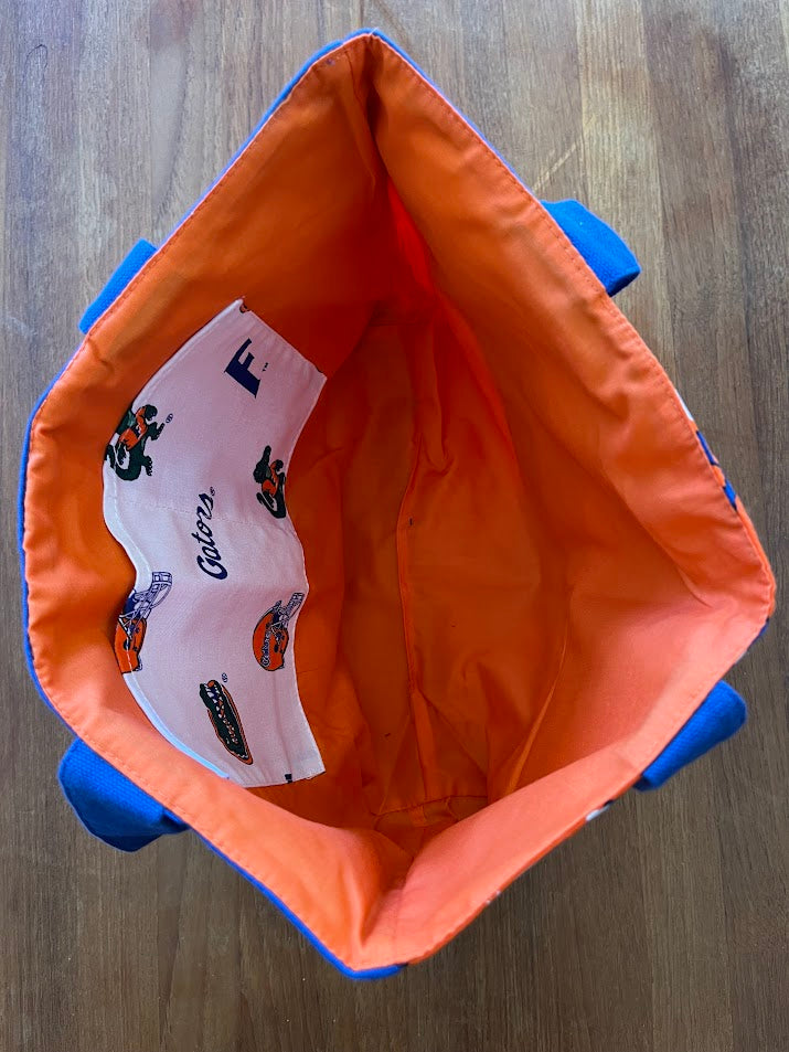 Inside the hibiscus Gators tote showing orange lining and Gators-print pocket