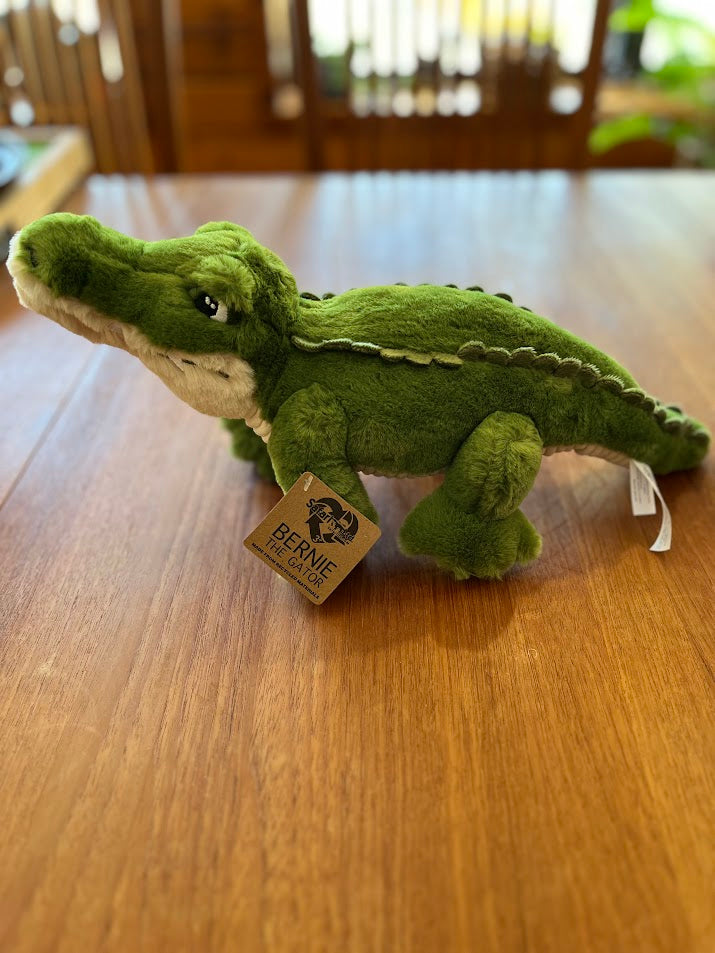 Green Bernie the Gator plush with hang tag, side view
