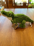 Green Bernie the Gator plush with hang tag, side view