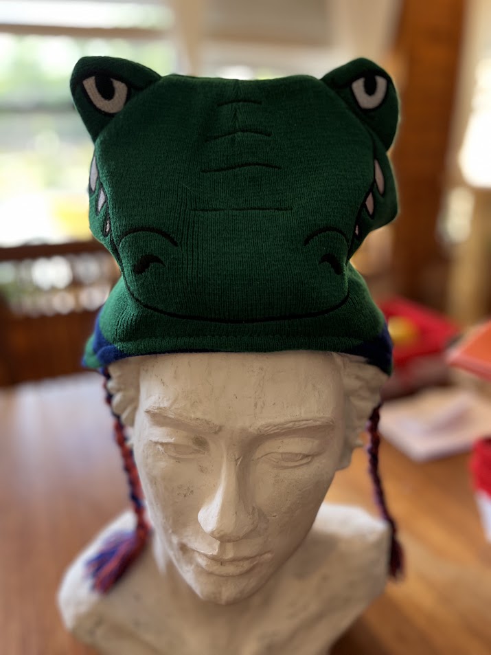 Green Gators mascot knit hat with gator face on display bust, front