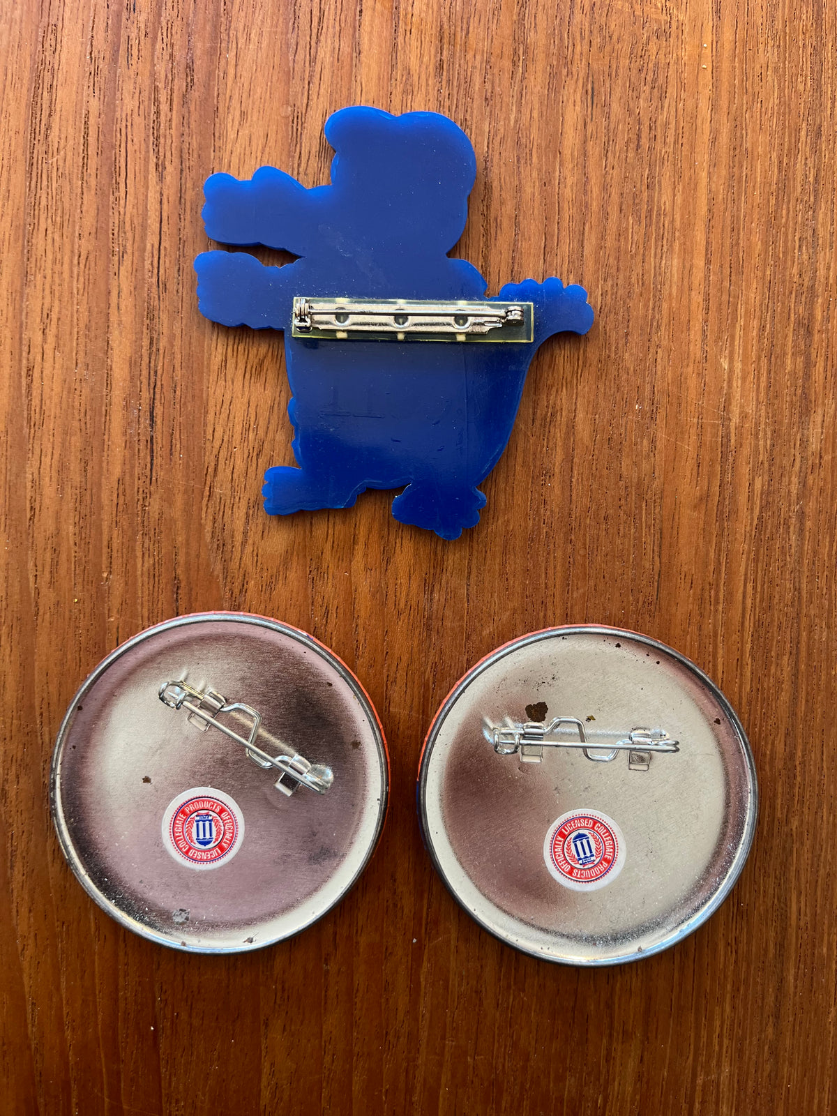Backs of the Albert pin and Beat Georgia buttons showing pin hardware