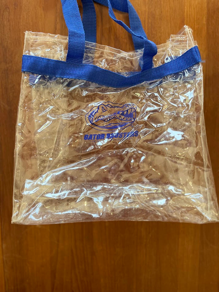Clear vinyl Gator Boosters stadium tote with blue web straps, front