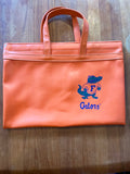 Orange vinyl Gators portfolio tote with small Albert and Gators script, front