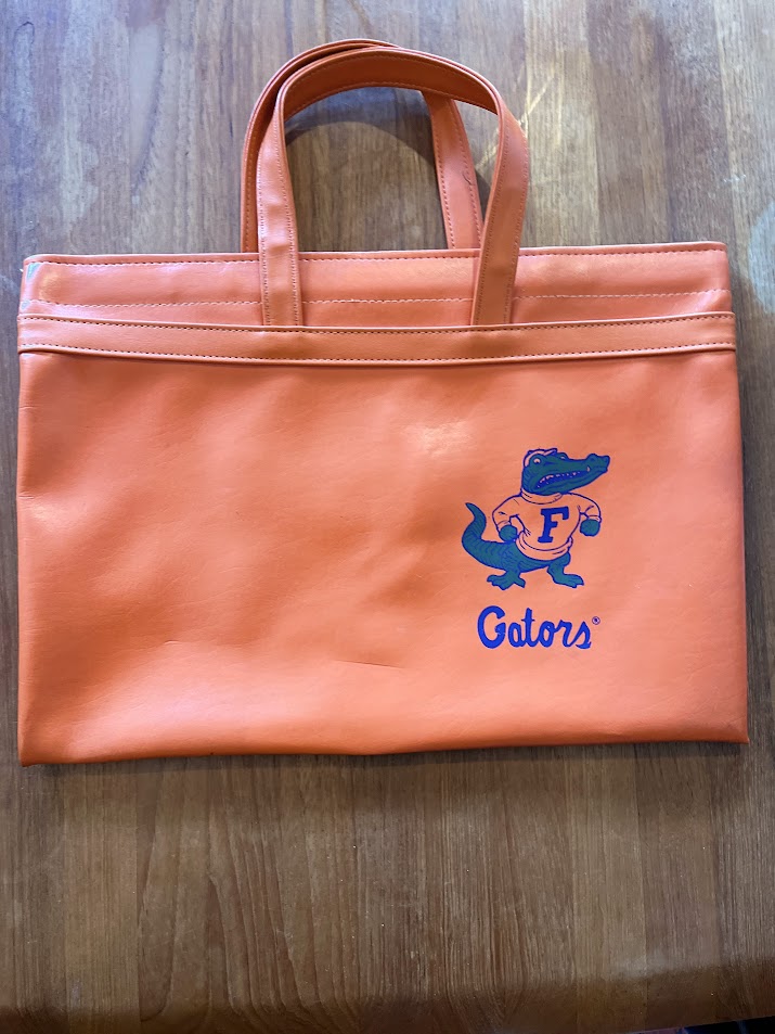Orange vinyl Gators portfolio tote with small Albert and Gators script, front