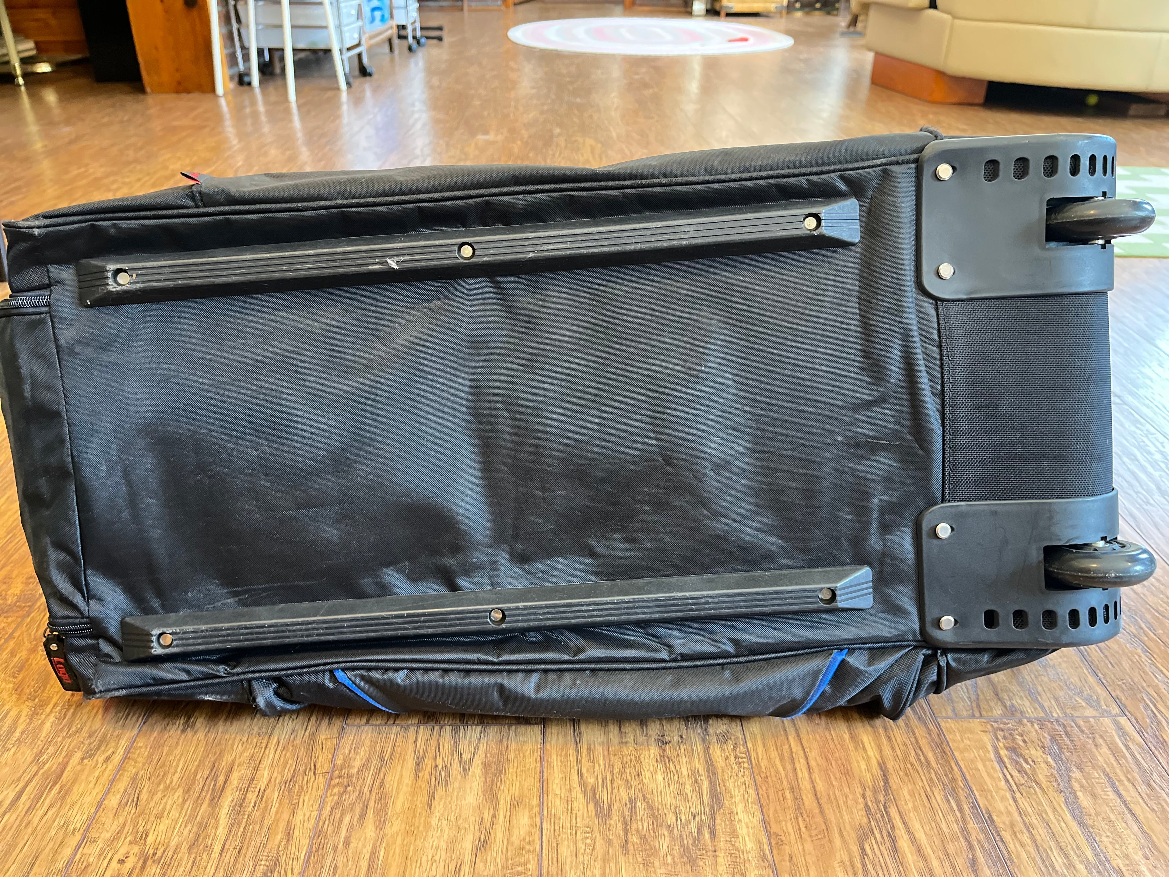 Underside of Gators rolling duffel showing rails and wheels