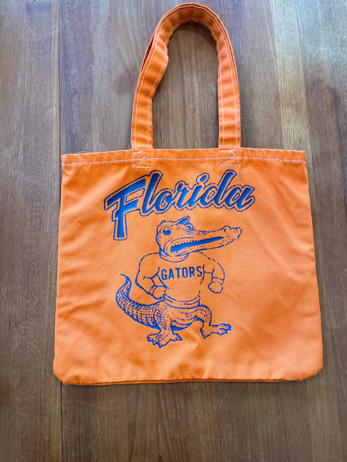 Orange cotton tote printed Florida with flexing Albert Gators mascot, front
