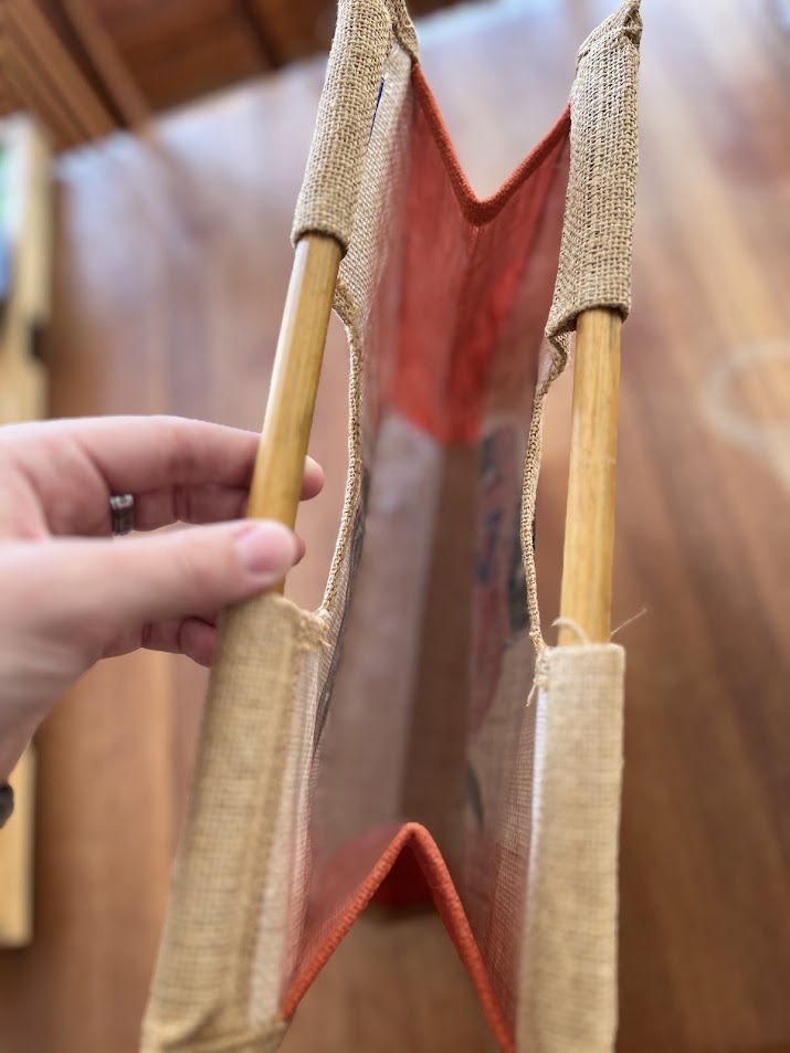 Burlap Gators tote held open showing dowel handles and interior