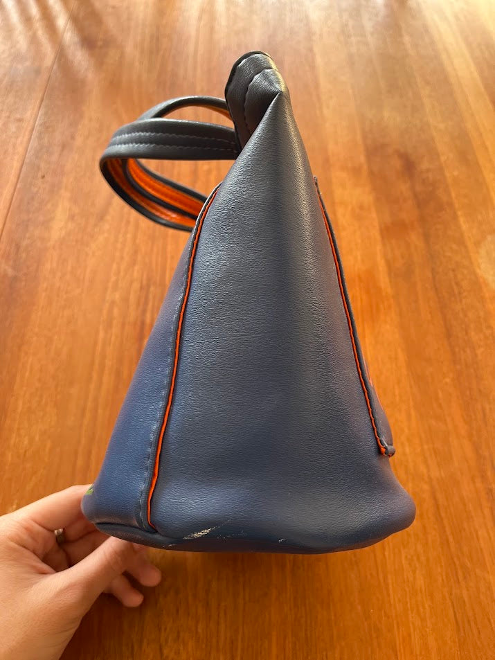 Blue vinyl Gators purse, side view with orange piping