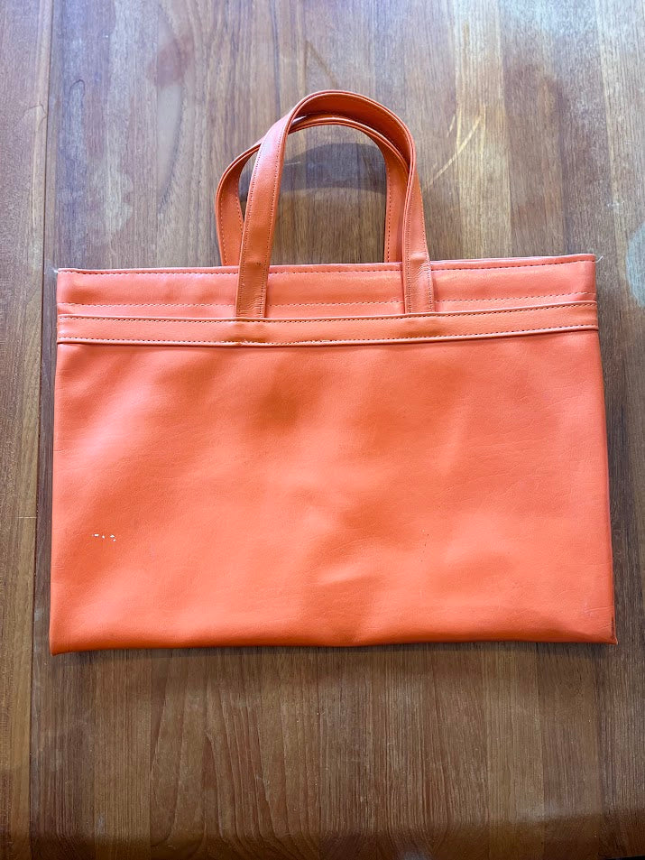 Back of orange vinyl Gators tote showing light scuffs