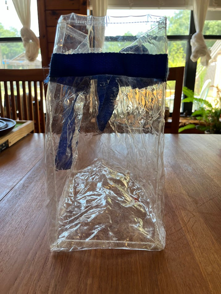 Clear Gator Boosters tote standing, showing creased vinyl